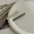 Detail of French acetate hair clips in shell white and navy blue on a ceramic plate - Grey Short 2pcs Set