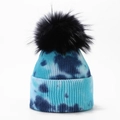 Detailed close-up of a blue tie-dye knit beanie with a fluffy black pom-pom and ribbed texture - Lake Blue and Deep Blue Tie-Dye (9#)