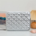 Close-up of quilted heart pattern on silver laptop sleeve with desktop setup - Silver Heart