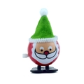 Close-up of wind-up Santa toy in red sphere shape with a green felt hat and white beard - Wind-up Ball Santa with Green Pointy Hat