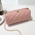 Pink quilted cylinder crossbody bag with golden floral buckle and chain strap - Pink