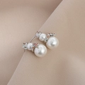 Detail of Christmas snowman earrings with white pearls and orange zircon accents - Silver