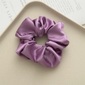 Elegant purple satin scrunchie hair tie on a decorative tray with a minimalist style - Lotus Root Purple