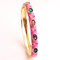 Pink enamel bangle with multicolored gemstones and gold plating on a white background - Rose Red