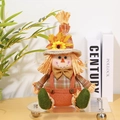 Détail du gnome de récolte avec chapeau de tournesol et accents en paille naturelle - Épouvantail en Salopette Mâle