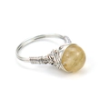Close-up of handmade wire-wrapped silver ring with round translucent yellow crystal stone - Yellow Stone
