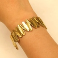 Golden textured geometric wave bangle for women with intricate stellar engravings - Oval Wave Thin Slices (11128)