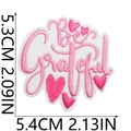 Macro shot of pink Be Grateful embroidered patch with heart motifs and measurements - No. 36 (Be Grateful)