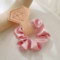 Pink satin scrunchie with a silky texture and glossy finish shown on a display stand - With Diamond Card / Pink