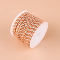 Orange, green, and white braided cotton cord with gold thread on a plastic spool - No.16 Orange Pink