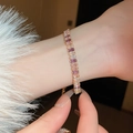 Detailed close-up of a gold-plated bracelet featuring gradient pink and purple square zircons - 38# Gold Gradient Square Style
