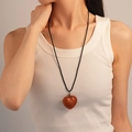 Detailed view of a brown leather heart pendant with fine stitching on a black cord - 2# Brown Heart Leather Sweater Chain