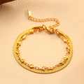 Flat lay of double-layer gold snake chain bracelet with heart and star pendants - Gold Star Heart Double Layer Blade Bracelet (T206)