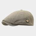 Detail of plaid newsboy hat featuring textured fabric and a small m logo patch - Adjustable / Gray