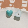 Macro shot of blue and white heart-shaped resin charms for DIY jewelry making - Dark Green Heart