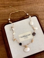 Detail of bohemian necklace with shells, starfish, and pink beads on a wooden tray - Shell Starfish Beaded Necklace Z-1327