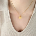 French design hollow heart pendant necklace in gold finish on female model neck - Golden Double Heart Style (P880)
