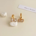 Close-up of 18K gold plated bow earrings with a crystal center and pavé accents - 18K Gold Plated Golden Bow Knot Zirconia Studs