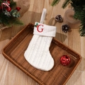 White knitted Christmas stocking with red embroidered letter G and holly berry accents - Letter G