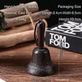 Vintage black cast iron hand bell with leather strap for cafe or bar table decor - Brown