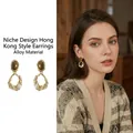 Detail of vintage gold geometric earrings with brown stones and pearls on an Asian model - Irregular Gold Ring with Gem and Pearl (1#)
