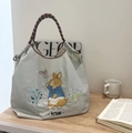 Blue canvas tote bag featuring Peter Rabbit embroidery and red striped braided handles - Light Grey Pastoral Rabbit