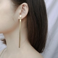 Elegant long gold tassel earring accessory for women on a model for beach style - Long Gold Tassel Style (E330-GO)