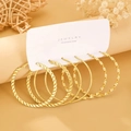 Three pairs of golden twisted hoop earrings on a display card for fashion styling - KC Gold (4152)