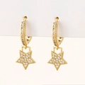 Close-up of gold star drop earrings with micro-pave white cubic zirconia on white card - J-Star
