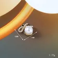 Elegante ciondolo a fiocco dorato con perla bianca e strass, misura 18mm x 17mm - Stile Fiocco (168)