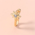 Close-up of golden star-shaped non-piercing nose ring with a central sparkling zircon - SE1205 Gold Star