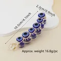 Detailed size view of the banana hair clip with evil eye motifs measuring 10.5cm long - 10.5cm 6-Round Eye Banana Clip