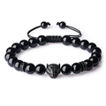 Macro shot of black bead bracelet featuring a detailed leopard head with green eyes - Polished Black Agate Bracelet (Leopard Head)