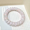 Pink floral print spiral hair tie in lucky clover style on a decorative display card - Violet