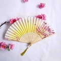 Chinese style folding fan with yellow tassels and pink cherry blossom pattern on wood - Pink & Yellow Cherry Blossom Butterfly Style (Women's Fan - 64)