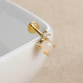 Macro shot of gold labret stud with round opal and white zircon on ceramic edge - Round with Zircon-E1341 / 1PC / Gold