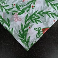 Detail of Christmas tissue paper featuring holly berries and bells on black background - Wreath-Green