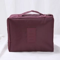 Portable burgundy travel makeup bag with grid texture and top handle for storage - Burgundy