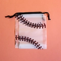 Frosted EVA drawstring storage bag with red baseball stitching design on a pink surface - White Baseball Style