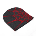 Close-up detail of the vibrant red spider web jacquard pattern on a knitted beanie - Dark Grey and Red (C)