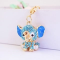 Cute golden elephant keychain with sparkling light blue rhinestones and enamel ears - Blue