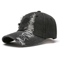 Detail shot of distressed dark denim baseball cap showing vintage frayed hole texture - Adult / Black