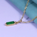 Macro shot of gold rectangle pendant necklace with green zircon birthstone detail - Emerald Green (May) - Gold