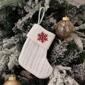White knitted Christmas stocking with red snowflake embroidery hanging on a festive tree - Embroidered Knitted Small Sock White Snowflake