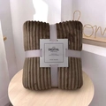 Brown flannel blanket with corn kernel texture, tied with a grey ribbon and white card - Elite Coffee
