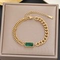 Gold stainless steel bracelet featuring an emerald green gemstone and asymmetric link chains - Gold Asymmetric Emerald Style (5224)