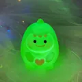 Green dinosaur night light for kids with glowing heart and soft silicone finish - Little Green Dragon