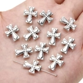 Silver alloy cross pendants for DIY jewelry making held in palm showing small size - Vintage Cross / 11x14mm