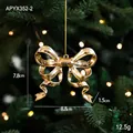 Golden bow Christmas tree ornament with reflective finish and warm festive lighting - Bowknot Style
