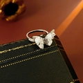 Detailed close-up of double butterfly rings with silver base on a vintage jewelry box - Silver Band with Blue Butterfly (HR2096)
